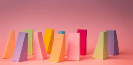 Colored makeup sponges on a delicate pink background. Abstract image.の写真素材