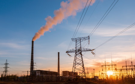 Thermal power stations and power lines during sunsetの写真素材