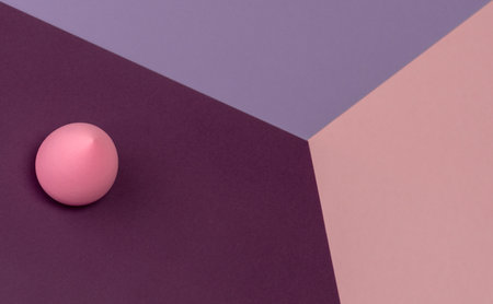 Top view of pink egg sponge on different pastel-colored backgrounds. Abstract imageの写真素材