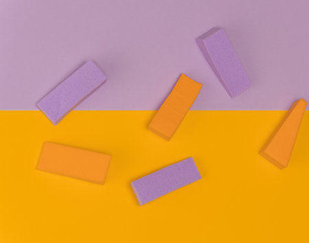 Top view of multi-colored sponges on different pastel-colored backgrounds. Abstract image.の写真素材