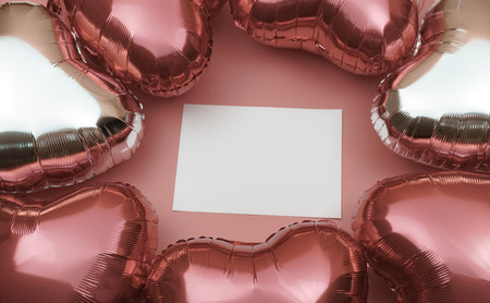 Foil balloons in the shape of a heart in shades of pink. Space for text. Heart-shaped balloon as a symbol of Valentine's Day.の写真素材
