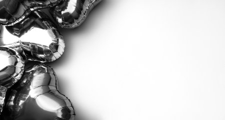 Black and white background of foil balloons in the shape of a heart. Space for text. Heart-shaped balloon as a symbol of valentine's day and love.の写真素材