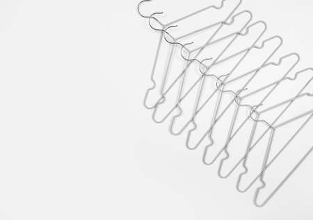 Metal clothes hangers on a light background. Wardrobes were hung for clothes. Place for text.の写真素材