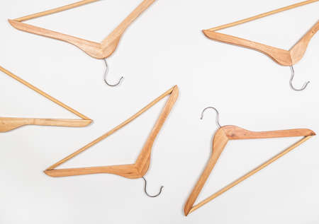 Clothes hangers made of wood on a light background. Hangers made of environmentally friendly material.の写真素材