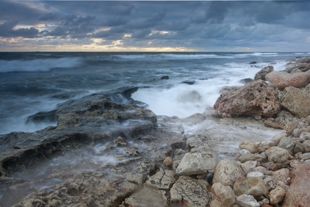 Beautiful rocky sea beach at the sunset