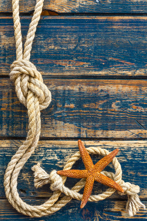 wooden background with starfish and marine ropeの写真素材