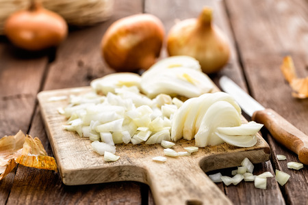 raw onion chopped on wooden boardの写真素材