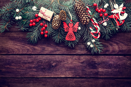 Christmas fir tree with decoration on dark wooden backgroundの写真素材