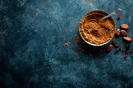 Cocoa powder and cacao beans on dark background, top viewの写真素材