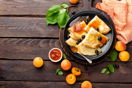 Pancakes with fresh blackcurrant and apricot jamの写真素材