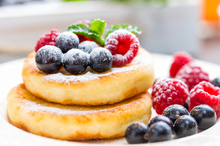 Cottage cheese pancakes, syrniki, curd fritters with berriesの写真素材