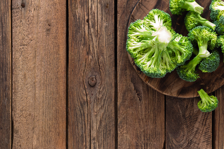 Fresh broccoli on wooden rustic table, top viewの写真素材