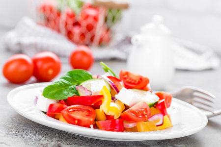 Tomato salad with fresh bell pepper, red onion and feta cheese. Healthy eatingの写真素材