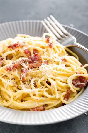 Carbonara pasta, spaghetti with pancetta, egg, hard parmesan cheese and cream sauce. Traditional italian cuisine. Pasta alla carbonaraの写真素材