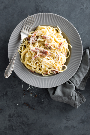 Carbonara pasta, spaghetti with pancetta, egg, hard parmesan cheese and cream sauce. Traditional italian cuisine. Pasta alla carbonaraの写真素材