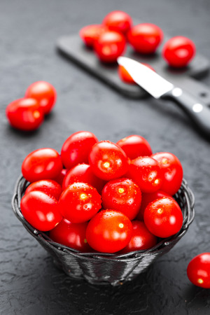 Tomatoes. Fresh tomatoes in basket on tableの写真素材