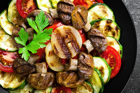 Salad with fresh and grilled vegetables and mushrooms. Vegetable salad with grilled champignons. Vegetable salad on plateの写真素材