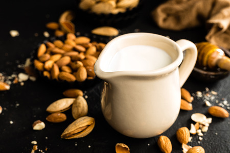 Homemade almond milk in jug. Almond milk and almondsの写真素材