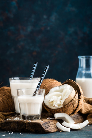 Fresh coconut milk in glass bottle, vegan non dairy healthy drinkの写真素材
