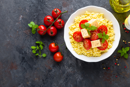 Millet porridge with tomatoes and cheeseの写真素材