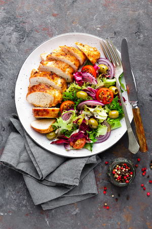 Grilled chicken meat, breast, fillet and fresh vegetable saladの写真素材