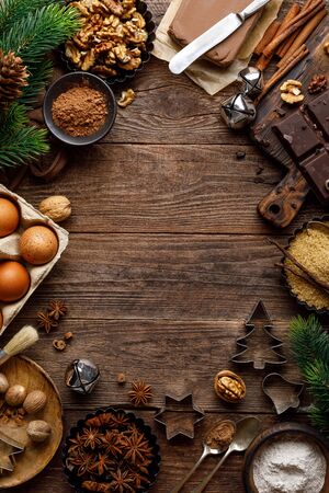 Christmas or new year culinary rustic wooden background with food ingredients for cooking festive dishes, xmas baking. Holiday cooking frame for Noel pastry on wooden tableの写真素材
