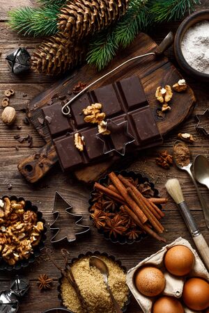 Christmas or new year culinary rustic wooden background with food ingredients for cooking festive dishes, xmas baking. Holiday cooking frame for Noel pastry on wooden tableの写真素材