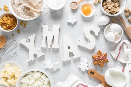 Christmas or Xmas baking culinary background. Ingredients for cooking pastry on kitchen table.  X-mas or Noel holiday festive decorations. Greeting cardの写真素材