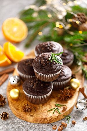 Christmas muffins. Chocolate Xmas or Noel festive bake with decorations and fir treeの写真素材