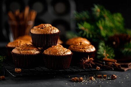Christmas cinnamon muffins on black backgroundの写真素材