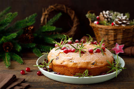 Christmas cranberry fruit cake with decorations on wooden backgroundの写真素材