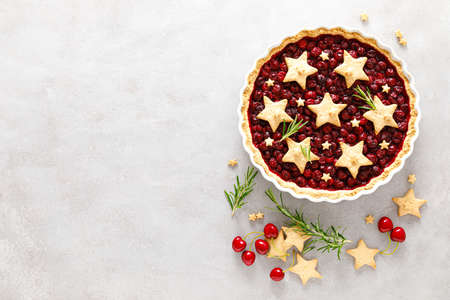 Homemade cherry pie, tart with star shaped cookiesの写真素材