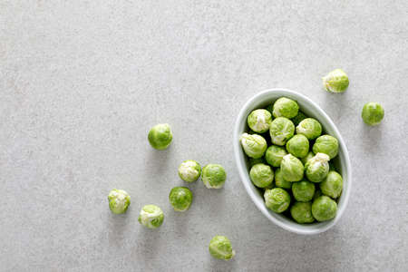 Fresh green brussels sprouts on cooking kitchen table. Top viewの写真素材