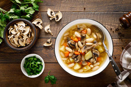 Mushroom soup with kidney bean, potato and carrot. Top view, copy spaceの写真素材