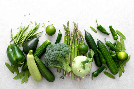 Green vegetables. Fresh green produce. Healthy vegetarian food concept background. Flat lay. Top...