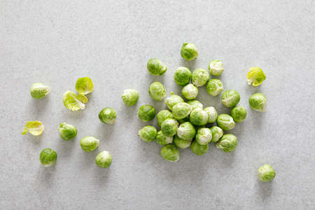 Fresh green brussels sprouts on cooking kitchen table. Top view