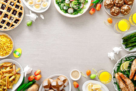 Easter festive table with salmon, asparagus, salad, potato, muffins and berry pie