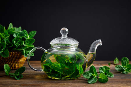 Mint tea, fresh herbal drink in a glass teapot with fresh leavesの写真素材