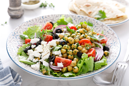 Mediterranean Greek and chickpea salad with fresh vegetables and feta cheeseの写真素材