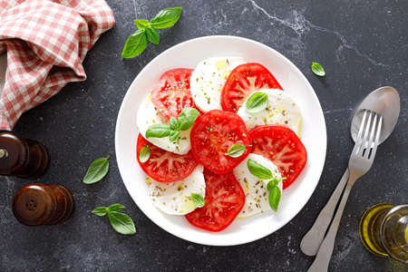 Caprese Salad with fresh tomatoes, basil and mozzarella cheese, top view