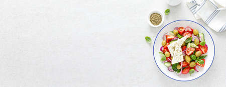 Banner salad. Greek or horiatiki salad with fresh vegetables and feta cheese, dressed with olive oil, traditional Greek cuisine salad. Top view. Bannerの写真素材