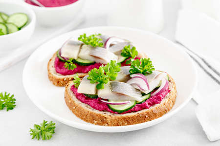 Sandwiches, toasts with salted herring and beetroot pateの写真素材
