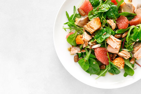 Grilled salmon salad with grapefruit, almonds and salad mix. Top viewの写真素材