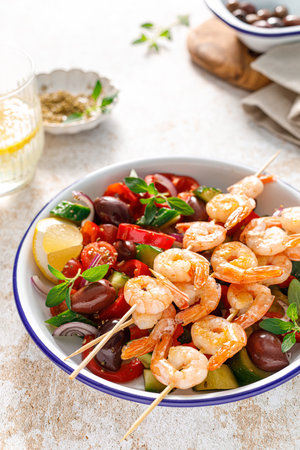 Shrimp kebab roasted on skewers and fresh vegetable saladの写真素材