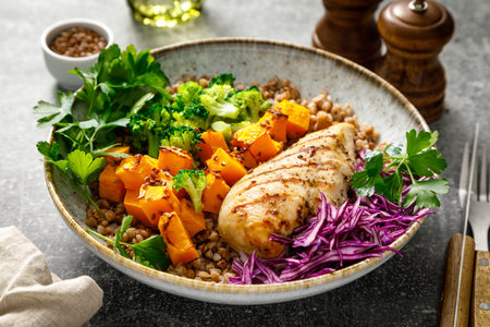 Grilled chicken breast with buckwheat, roasted butternut squash, broccoli, fresh greens and red cabbage. Healthy food, lunch menuの写真素材
