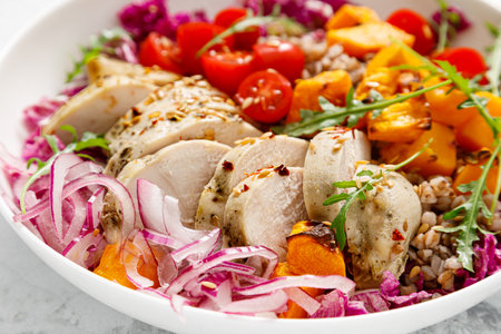 Chicken breast fillet and buckwheat bowl, grilled butternut squash and fresh vegetable salad with arugula and tomatoes, healthy food, lunch menu, top viewの写真素材