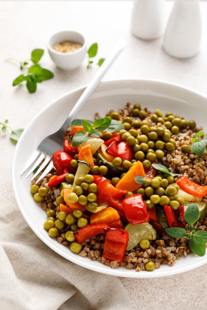 Buckwheat with roasted vegetables and green peasの写真素材