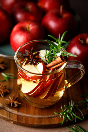 Christmas mulled apple cider with cinnamon, anise and rosemary. Traditional hot drink or beverage, festive Xmas or New Year winter cocktailの写真素材