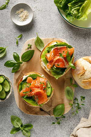 Salmon sandwiches with cream cheese, fresh romaine lettuce and cucumber, top down viewの写真素材