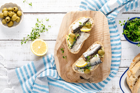 Sardines sandwiches on a white wooden background. Mediterranean food. Top viewの写真素材